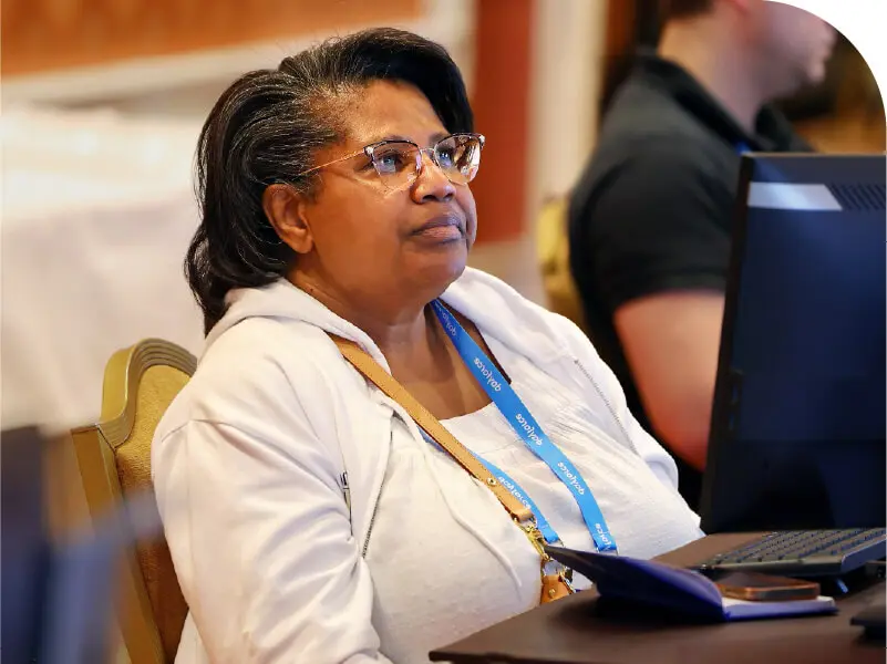 Attendee listens and takes notes during a Dayforce Discover breakout session
